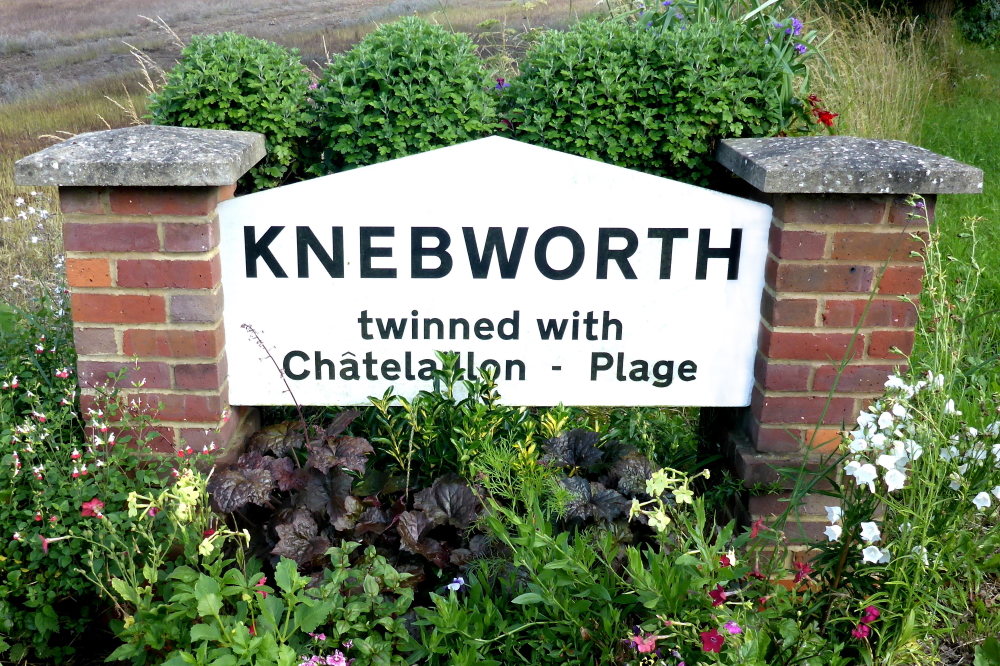 This image: A photo of the sign at the
					 entrance to Knebworth, surrounded by flowers. The sign reads:
					 Knebworth twinned with Chatelaillon-Plage. The map: the map has moved
					 to a bird's eye view of the site, with two flashing gold map markers,
					 which link to the survey and general feedback forms. Links for these
					 surveys are also accessible in the text below.